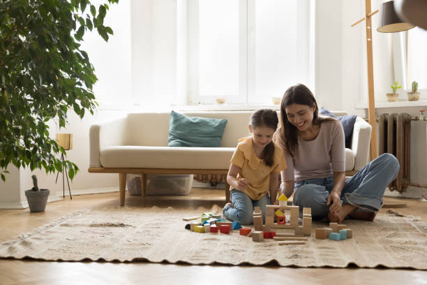 istock Mother with daughter spend time playing on floor with blocks 1970666673