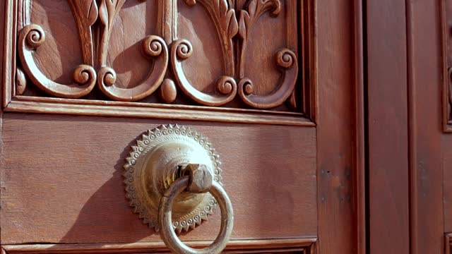 Old wooden door with rusty metal rivets, 3D animation, medieval, antique door opening with alpha matte. camera movement from top to bottom