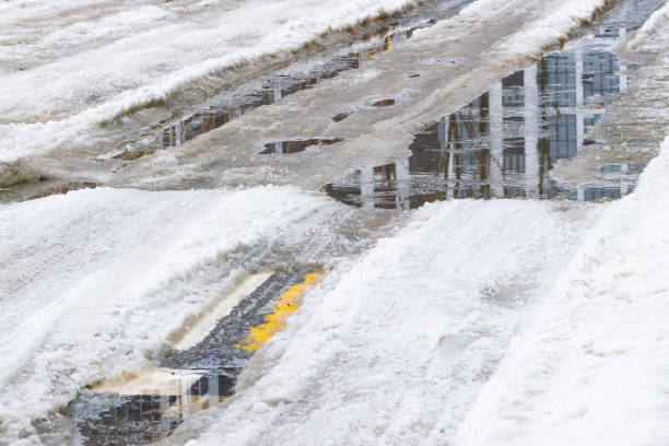 istock water in a car rut in winter. close-up 1970685567