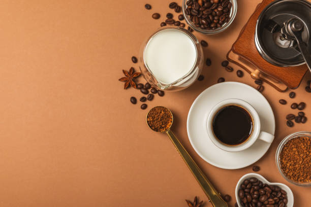 istock Ingredients for making coffee. Moka pot, turkish coffee pots (cezve), coffee grinder with coffee beans, milk, sugar and spices on a marble background. Drink preparation concept. Flat Lay.Copy space. 1970723040