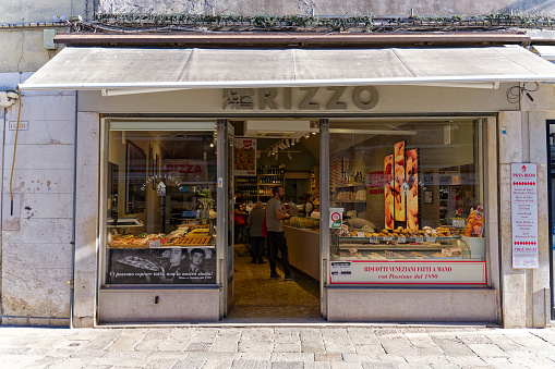 Shop window of grocery store named Rizzo at Italian City of Venice on a sunny summer day. Photo taken August 7th, 2023, Venice, Italy.