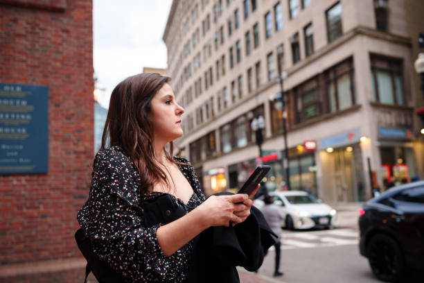istock Woman using cell phone at the city 1970733929