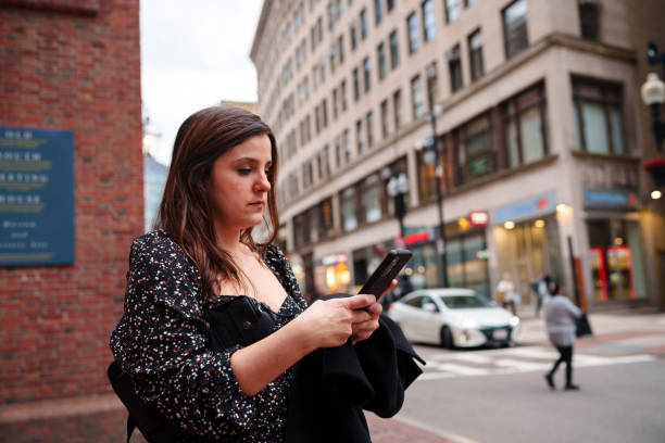 istock Woman using cell phone at the city 1970734456