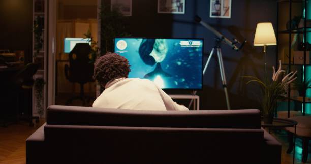 istock Man plays on console system with Ray tracing graphics and high FPS, zoom out shot 1970737569