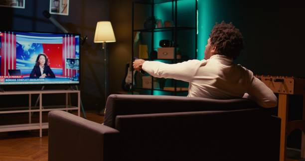 istock Man watching newscasting presenter talking about various stories on news channel 1970746927