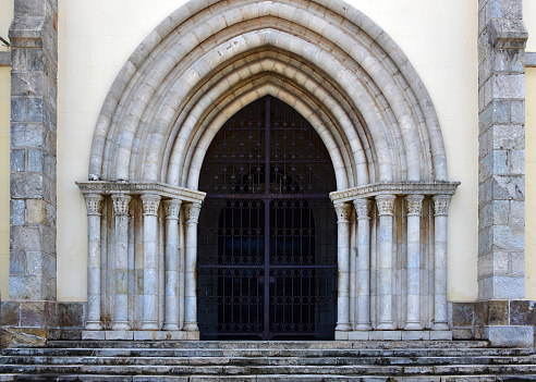 Nouméa, South Province, Grande Terre, New Caledonia: Catholic Cathedral of Saint Joseph - built using prison labor, according to the plans of a former convict, a certain Labulle. Neo-Gothic gate with stone archivolts using voussoirs, supported by five jambs on each side.