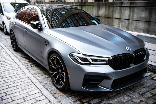 New York City, USA - July 15, 2023: BMW F90 M5 silver color car parked, corner view.