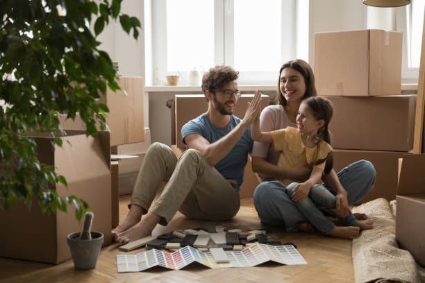 istock Family on relocation giving high five, start new house repairs 1970781124
