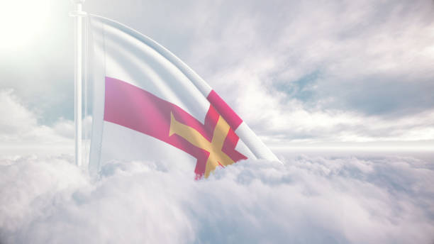 guernsey flag waving above the clouds, the concept of liberty and patriotism, national flag waving proudly above the clouds, symbolizing freedom, independence day, celebration, freedom, patriotic, power and freedom, - guernsey cattle fotografías e imágenes de stock