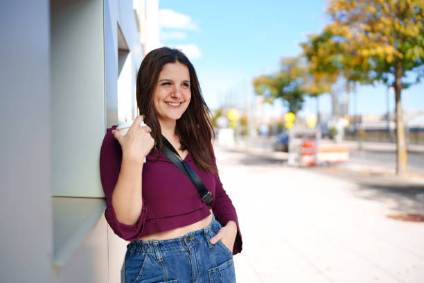 istock Woman with coffee cup in the city 1970798230