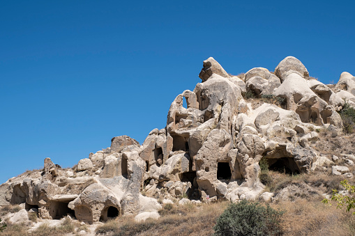 typical rock formations of Cappadocia, with sandstone rocks of volcanic origin eroded in a capricious way by water, and caves dug in them, horizontal