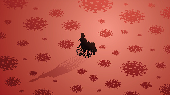 A man in a wheelchair surrounded by Covid viruses looking up on red background.