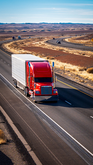 A white semi-truck heading east on Interstate 70 in eastern Utah