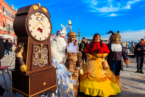 Venice, Italy - February 11, 2023: Unidentified people dressed as Beauty and the Beast characters during the annual Venice Carnival in Venice, Italy