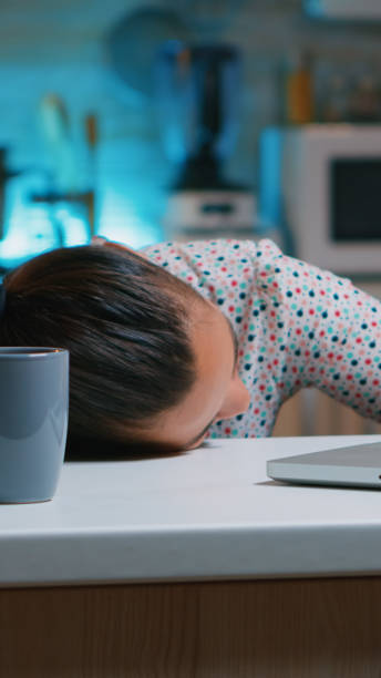 istock Woman working at night falling asleep on desk 1970877201