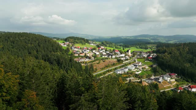 aerial over forest and village in Muehlviertel, Upper Austria