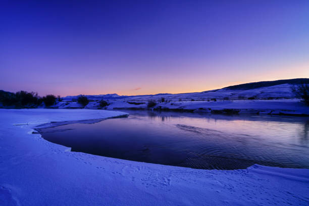 Gore Range Colorado River at Dusk Scenic Mountain Landscape - Scenic views with colorful sky reflecting in water. Colorado River near Kremmling, Colorado USA.