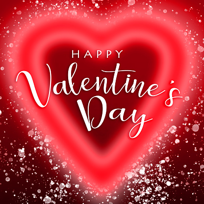 Glowing heart shape with HAPPY VALENTINE'S DAY lettering and lots of glittering particles. Can be used as a design for Valentine's day holiday greeting cards or posters.