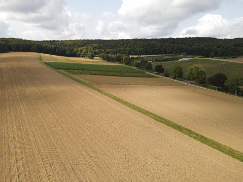 Aerial view of plowed farm fields with soil in summer
