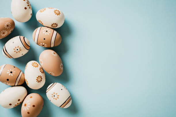 istock Elegant Easter eggs decorated flowers print on pastel blue background. Flat lay, top view with copy space. 1970916095