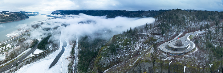 A light dusting of snow covers the Columbia River Gorge near the Crown Point Vista House. This scenic area, not far east of Portland, Oregon, is full of waterfalls and epic outdoor scenery.