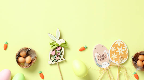 istock Happy Easter greeting card, banner, poster. Flat lay Easter bunny, eggs, nests, carrot on light green background. 1970935742