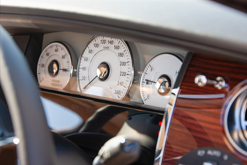 white classic dials, and gauges , car indoors front view, daytime