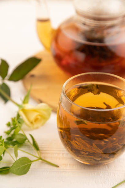 istock Red tea with herbs in glass teapot on white wooden. Top view, selective focus. 1970961933
