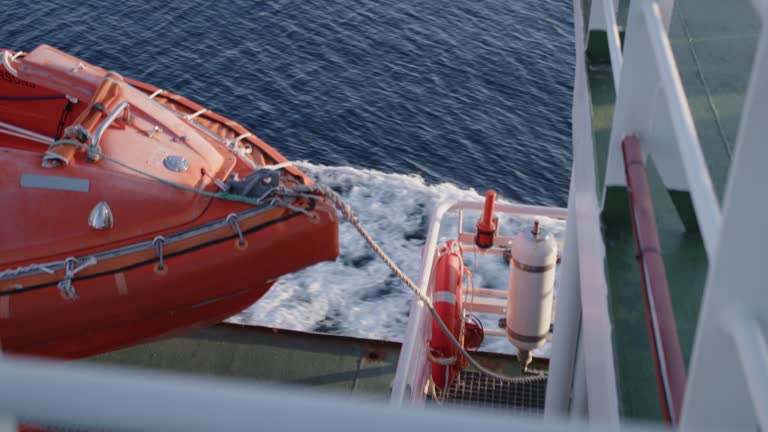 Orange Lifeboat And Lifebuoy On Ferry Voyage