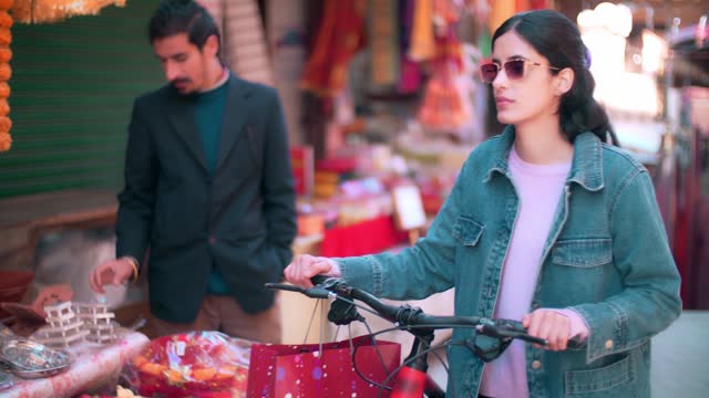 Woman uses a bicycle while shopping within a 15-minute city.