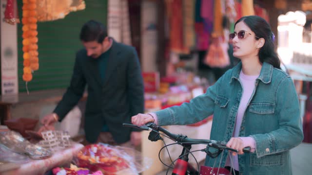 Woman uses a bicycle while shopping within a 15-minute city.