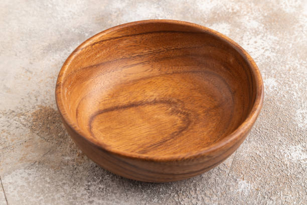istock Empty brown wooden bowl on brown concrete. Side view, copy space 1970998542