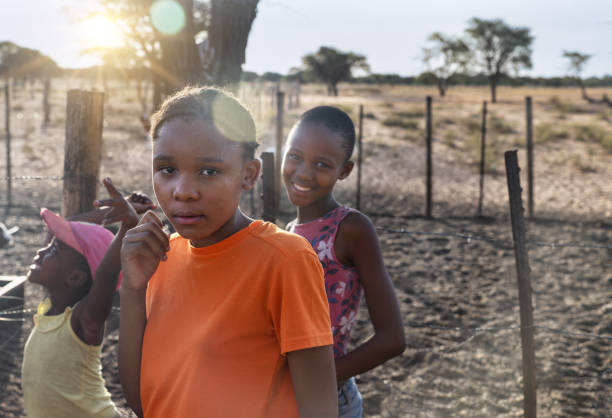 village african kids , playing in the yard at sunset