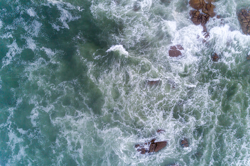 drone aerial view of the seashore with rough seas on a rocky shore