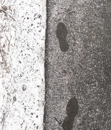 Closeup of footsteps in snow.