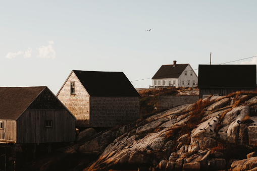 Fisherman's sheds and a house shot at low tide along the coast of Nova Scotia, Canada. Shot with a Canon 5D Mark IV.
