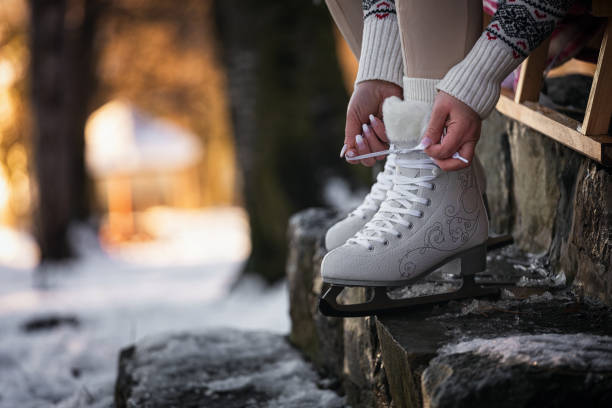 Close-up of woman ice skating on a pond on a freezing winter day