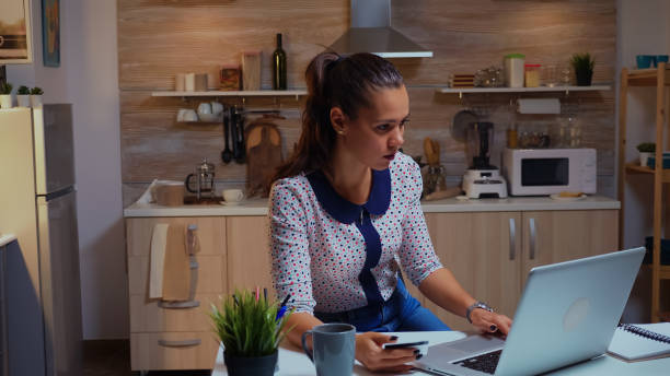 istock Lady holding credit card while doing online transaction 1971093681