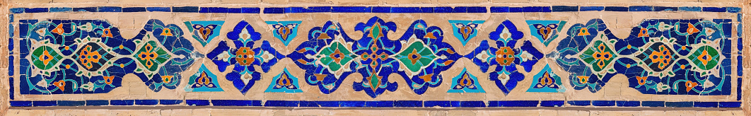 Traditional Uzbek ornament. Pattern of the ceramic tile on the wall of madrasah. Banner. Registan, Samarkand, Uzbekistan