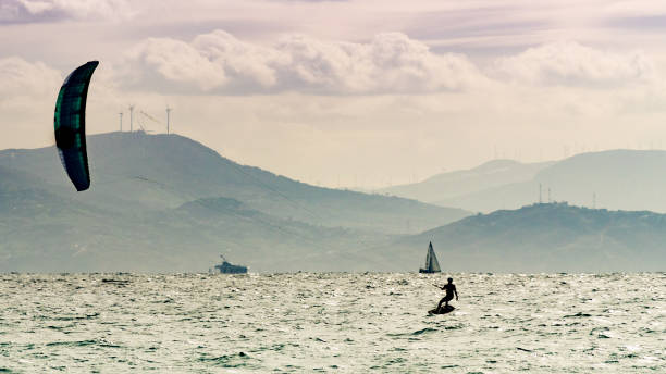 istock Kite surfer riding waves. Kiteboarding sport. 1971104825