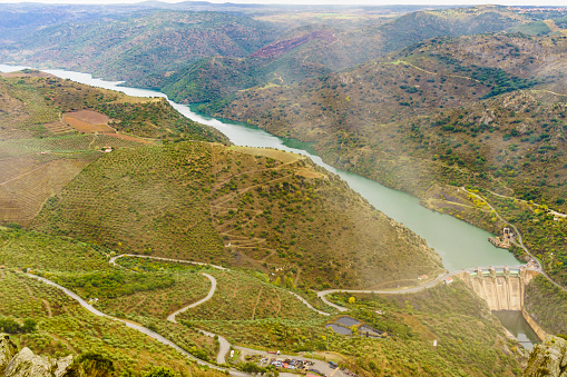 Mountain landscape and Douro river with spanish Saucelle Dam. Border between Portugal and Spain. National Park. View from portuguese Penedo Durao lookout.