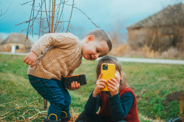 children with mobile phones outside