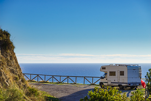 Caravan on spanish coast, seaside cliffs of Maro Cerro Gordo. Costa del Sol, Andalusia Spain. Motorhome vacation trip.