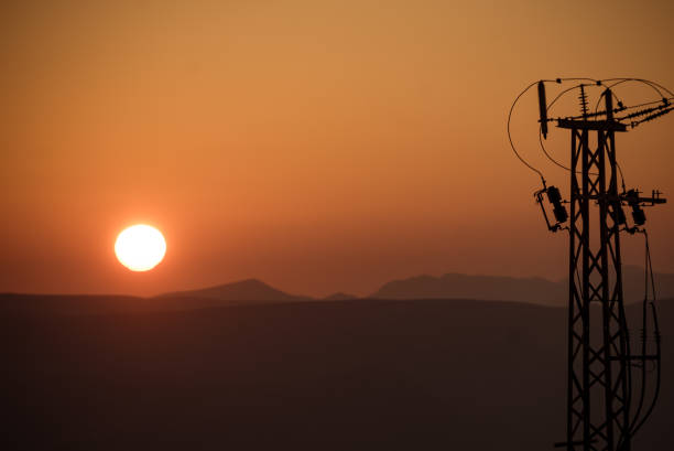 istock High voltage towers on coast at sunset 1971148984