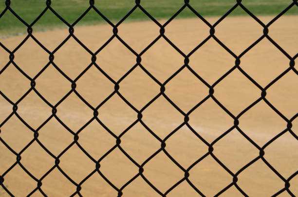 istock Baseball Diamond through a chain link fence 1971177681
