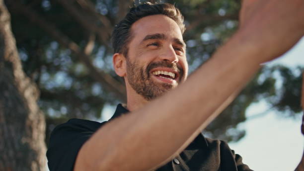 istock Cheerful tourist video calling cellphone on tree background closeup. Man talking 1971181351