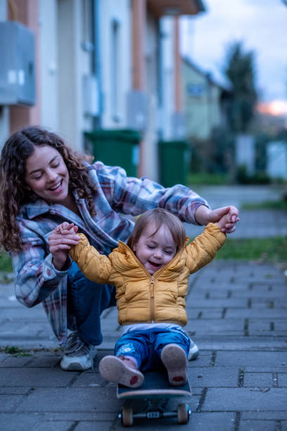 istock sister pushes baby on skates 1971189927