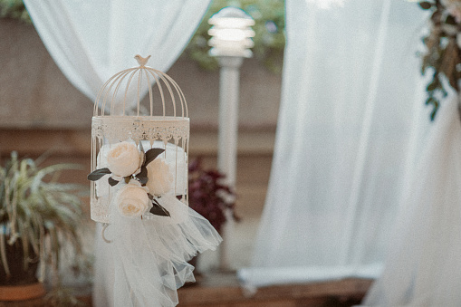 The big day - Elegant wedding decoration, white roses and flower cage