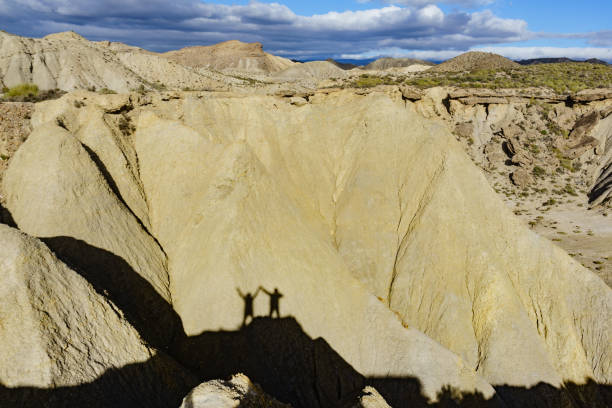 istock Shadow of two people on rock mountain 1971213131