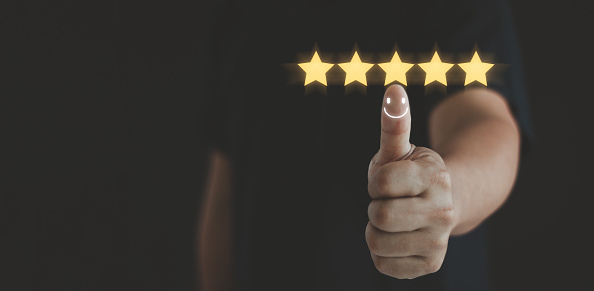Customer satisfaction concept. Hand with thumb up positive emotion happy smile face icon and five star with copy space, feedback, survey, standard quality. User give rating service experience review.